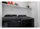 Modern laundry room featuring a shelf and Samsung black stainless steel washer and dryer at 4352 N 91St Gln, Phoenix, AZ 85037