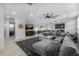 Open living room boasts a large sectional sofa, modern ceiling fan, and stylish decor at 4352 N 91St Gln, Phoenix, AZ 85037