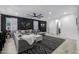 Comfortable living room with a stylish sectional sofa, black accent wall, and modern decor at 4352 N 91St Gln, Phoenix, AZ 85037