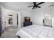 Bright main bedroom featuring a ceiling fan, television, and backyard access at 4352 N 91St Gln, Phoenix, AZ 85037