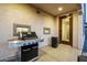 A built-in stainless steel gas grill in the outdoor kitchen, adjacent to the patio at 4352 N 91St Gln, Phoenix, AZ 85037