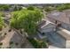 Aerial view of home showcasing mature trees, two-car garage, and a well-manicured landscape at 4466 S Brice --, Mesa, AZ 85212
