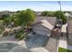 Aerial view of the house showcasing a two-car garage, driveway, and desert landscaping at 4466 S Brice --, Mesa, AZ 85212