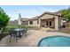 Backyard patio with a sparkling pool, table with chairs, and outdoor seating at 4466 S Brice --, Mesa, AZ 85212