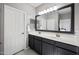 Bathroom with double sink vanity with a large mirror and modern lighting fixtures at 4466 S Brice --, Mesa, AZ 85212
