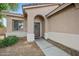 Inviting front entrance with an arched doorway and a charming wreath, set in a neutral stucco home at 4466 S Brice --, Mesa, AZ 85212
