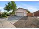 View of single-story home with neutral stucco and a well-kept yard with easy access to the side yard at 4466 S Brice --, Mesa, AZ 85212