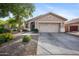 Single-story home with neutral stucco and an attached two-car garage, set against a bright blue sky at 4466 S Brice --, Mesa, AZ 85212