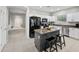 Stylish kitchen with granite countertops, white cabinets, modern appliances, and a central island with bar seating at 4466 S Brice --, Mesa, AZ 85212