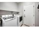 Functional laundry room with washer, dryer, and shelving for storage, providing convenience at 4466 S Brice --, Mesa, AZ 85212