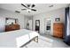 Bright main bedroom featuring wood furniture, neutral walls, and a ceiling fan at 4466 S Brice --, Mesa, AZ 85212