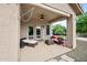 Inviting covered patio seating area with neutral colors and ceiling fan at 4466 S Brice --, Mesa, AZ 85212