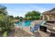 Backyard pool with rock waterfall feature, lush plants, and patio seating at 4466 S Brice --, Mesa, AZ 85212