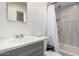 Bathroom showcasing a new shower, modern tiling, and a sink with gray vanity at 4545 N 49Th Ave, Phoenix, AZ 85031
