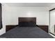 Bedroom highlighting a dark wood bed frame, neutral tile floors, and a mirrored closet at 4545 N 49Th Ave, Phoenix, AZ 85031