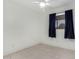 Simple bedroom with white ceiling fan and neutral tiled flooring at 4545 N 49Th Ave, Phoenix, AZ 85031