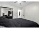 Bedroom showcasing dark furniture, neutral tile floors, and a mirrored closet at 4545 N 49Th Ave, Phoenix, AZ 85031