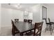 Elegant dining area featuring a large table, bar stools and stylish lighting at 4545 N 49Th Ave, Phoenix, AZ 85031