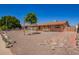 Single-story home with desert landscaping featuring a young tree, complemented by a brick facade at 4545 N 49Th Ave, Phoenix, AZ 85031