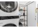 Neat laundry room featuring a modern washer/dryer and storage shelving at 4545 N 49Th Ave, Phoenix, AZ 85031