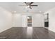 Spacious living room featuring gray floors, a sliding glass door, and a modern ceiling fan at 4545 N 49Th Ave, Phoenix, AZ 85031
