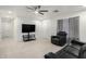 Inviting living room with ample seating, a ceiling fan, and a large-screen TV at 4545 N 49Th Ave, Phoenix, AZ 85031