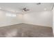 Large room showcasing gray flooring, white walls, and a modern ceiling fan at 4545 N 49Th Ave, Phoenix, AZ 85031