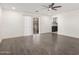 Bright living room showcasing gray flooring, white walls, and a modern ceiling fan at 4545 N 49Th Ave, Phoenix, AZ 85031