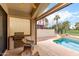 Outdoor patio with a built-in grill and view of the pool and lush backyard, great for entertaining at 4738 N Greenview W Cir, Litchfield Park, AZ 85340