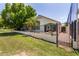 Backyard area with gated access; perfect for or pets with lawn, block fencing, and desert landscaping at 4738 N Greenview W Cir, Litchfield Park, AZ 85340