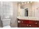 Bathroom featuring a wood vanity with a large mirror and convenient storage, paired with a toilet at 4738 N Greenview W Cir, Litchfield Park, AZ 85340