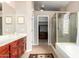 Bathroom with dual sinks, separate shower, bathtub, and walk-in closet at 4738 N Greenview W Cir, Litchfield Park, AZ 85340