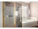 Bathroom featuring a separate glass shower and tub with natural light at 4738 N Greenview W Cir, Litchfield Park, AZ 85340