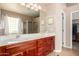 Bathroom features a dual sink vanity, large mirror, separate shower, and walk-in closet at 4738 N Greenview W Cir, Litchfield Park, AZ 85340