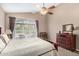 Primary bedroom with ceiling fan, access to patio, and a large closet at 4738 N Greenview W Cir, Litchfield Park, AZ 85340
