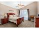 Light-filled primary bedroom featuring a ceiling fan and access to the pool and patio at 4738 N Greenview W Cir, Litchfield Park, AZ 85340