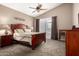 Light-filled primary bedroom with ceiling fan, plush carpet, and access to the patio and pool at 4738 N Greenview W Cir, Litchfield Park, AZ 85340