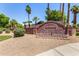 Litchfield Greens community sign is surrounded by lush greenery and palm trees, creating a welcoming and serene atmosphere at 4738 N Greenview W Cir, Litchfield Park, AZ 85340
