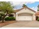 Charming single Gathering home with a wide driveway leading to a large garage and manicured front yard at 4738 N Greenview W Cir, Litchfield Park, AZ 85340