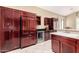 Gourmet kitchen boasts wine fridge, custom cabinets, stone counters, and stainless steel appliances at 4738 N Greenview W Cir, Litchfield Park, AZ 85340