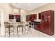 Bright kitchen with eat-in bar, dark wood cabinets, and updated appliances at 4738 N Greenview W Cir, Litchfield Park, AZ 85340