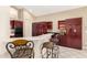 Charming kitchen with breakfast bar, dark wood cabinets, and tile flooring at 4738 N Greenview W Cir, Litchfield Park, AZ 85340