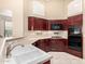 Bright kitchen features dark wood cabinets, tile floors, and stainless steel appliances at 4738 N Greenview W Cir, Litchfield Park, AZ 85340