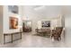 Open-concept living room flows into dining area with tile floors and neutral walls, creating a bright space at 4738 N Greenview W Cir, Litchfield Park, AZ 85340