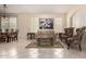 Bright living room boasts neutral tile flooring and provides access to the connected dining area at 4738 N Greenview W Cir, Litchfield Park, AZ 85340
