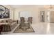 Formal living room features elegant seating, a decorative rug, and neutral tile flooring at 4738 N Greenview W Cir, Litchfield Park, AZ 85340