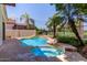 Inviting pool with a spa, surrounded by lush landscaping and a patio, providing a relaxing outdoor retreat at 4738 N Greenview W Cir, Litchfield Park, AZ 85340