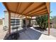 Cozy backyard with covered patio, outdoor dining area, and desert plants creating a private oasis at 4765 E Charleston Ave, Phoenix, AZ 85032