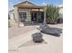 Relaxing backyard with covered patio, lounge chairs, and a fire pit at 4765 E Charleston Ave, Phoenix, AZ 85032