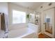 Modern bathroom with separate tub and shower, plus a privacy window at 4765 E Charleston Ave, Phoenix, AZ 85032